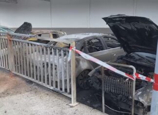 Arden catro vehículos estacionados nun taller en Araño